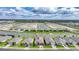 Aerial shot of community featuring scenic lake views, manicured lawns, and modern home designs at 1409 Remington Trace Dr, Port Charlotte, FL 33953