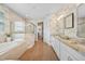 Bright bathroom features double sinks, soaking tub, and a glass-enclosed shower at 1409 Remington Trace Dr, Port Charlotte, FL 33953