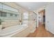 Bright bathroom featuring a soaking tub and shower behind glass partition at 1409 Remington Trace Dr, Port Charlotte, FL 33953