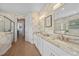 Elegant bathroom with double sinks, marble countertops, patterned wallpaper, and a separate shower at 1409 Remington Trace Dr, Port Charlotte, FL 33953