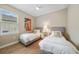 Bright bedroom with two twin beds, ceiling fan, and a window with exterior views at 1409 Remington Trace Dr, Port Charlotte, FL 33953