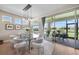 Elegant dining room with a glass table, stylish chandelier, and sliding glass doors leading to outdoor patio at 1409 Remington Trace Dr, Port Charlotte, FL 33953