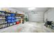 Spacious garage with shelving providing ample storage space, complemented by a clean, concrete floor at 1409 Remington Trace Dr, Port Charlotte, FL 33953