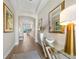 Welcoming foyer with wood-look tile flooring, elegant decor, and arched passageway at 1409 Remington Trace Dr, Port Charlotte, FL 33953