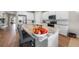 Kitchen island with stainless steel appliances, stone countertops and a bowl of fruit at 1409 Remington Trace Dr, Port Charlotte, FL 33953