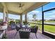 Screened lanai showcasing outdoor seating, views of the serene pond, and lush landscaping at 1409 Remington Trace Dr, Port Charlotte, FL 33953