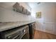Laundry room with granite counters, storage, and modern washer/dryer units at 1409 Remington Trace Dr, Port Charlotte, FL 33953