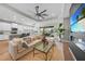 Spacious living room blending seamlessly with the kitchen and dining area, leading to an outdoor patio at 1409 Remington Trace Dr, Port Charlotte, FL 33953
