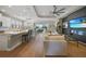 Open-concept living space with island kitchen, modern ceiling fan, and sliding doors to patio at 1409 Remington Trace Dr, Port Charlotte, FL 33953
