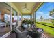 Beautiful covered patio with ceiling fan, comfortable seating, and a lovely view of the lake at 1409 Remington Trace Dr, Port Charlotte, FL 33953