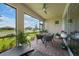 Inviting screened-in lanai with brick flooring, stylish seating, and picturesque water view at 1409 Remington Trace Dr, Port Charlotte, FL 33953