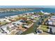 Aerial view of waterfront homes with private boat docks and canal access to the open ocean at 1456 Deer Creek Dr, Englewood, FL 34223