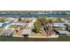 Waterfront property featuring boat lift, lush lawn, and mature trees in desirable Gulf access community at 1456 Deer Creek Dr, Englewood, FL 34223