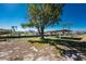 Waterfront backyard featuring boat dock with lift, grassy area, and mature shade tree at 1456 Deer Creek Dr, Englewood, FL 34223