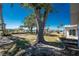 Waterfront backyard with mature trees, boat dock with lift, and well-maintained landscaping at 1456 Deer Creek Dr, Englewood, FL 34223