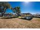A boat lift and a yard meet beneath a bright blue sky at 1456 Deer Creek Dr, Englewood, FL 34223