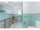 Retro bathroom with green tiling and white flooring, ready for remodel at 1456 Deer Creek Dr, Englewood, FL 34223
