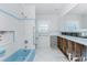 Blue bathroom with tiling, bathtub, shower, and vintage fixtures needs renovation at 1456 Deer Creek Dr, Englewood, FL 34223