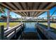 A covered boat lift sits at the edge of the canal for easy access to the water at 1456 Deer Creek Dr, Englewood, FL 34223
