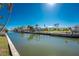 A picturesque canal view with lush greenery and palm trees on the banks at 1456 Deer Creek Dr, Englewood, FL 34223