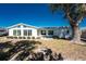 Bright, single-story home featuring lots of windows and a well-maintained lawn at 1456 Deer Creek Dr, Englewood, FL 34223