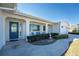 Inviting front porch with seating area and decorative features, framed by manicured shrubs and greenery at 1456 Deer Creek Dr, Englewood, FL 34223