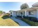 Charming single-story home with a well-manicured lawn and inviting front porch, plus established landscaping at 1456 Deer Creek Dr, Englewood, FL 34223