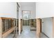 Open hallway and entryways showing flooring, walls, and doorway in need of repair at 1456 Deer Creek Dr, Englewood, FL 34223