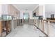 Open-concept kitchen area with white tile flooring, offering a bright and spacious layout for upgrades at 1456 Deer Creek Dr, Englewood, FL 34223