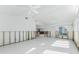 Bright, open living area with white tile flooring, and great potential for a new owner to make their own at 1456 Deer Creek Dr, Englewood, FL 34223