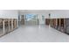 Open living space with white tile floors, large windows for natural light, plus unfinished drywall at 1456 Deer Creek Dr, Englewood, FL 34223