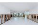 Bright living space featuring tile floors and large windows, framed by unfinished drywall and exposed wiring at 1456 Deer Creek Dr, Englewood, FL 34223