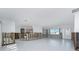 Open living space with white tile floors, large windows for natural light, plus unfinished drywall at 1456 Deer Creek Dr, Englewood, FL 34223