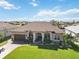 Aerial view of the house with a well-manicured front lawn and mature landscaping at 15578 Seafoam Cir, Port Charlotte, FL 33981