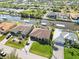 A high-angle view of a house with a large lawn, located in a waterfront neighborhood at 15578 Seafoam Cir, Port Charlotte, FL 33981