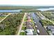 An aerial view of a waterfront neighborhood in a coastal community with canals and single-Gathering homes at 15578 Seafoam Cir, Port Charlotte, FL 33981