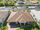 Bird's eye view of a single Gathering home in a waterside neighborhood with lush landscaping at 15578 Seafoam Cir, Port Charlotte, FL 33981