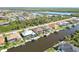 An aerial view of a waterfront neighborhood with houses that have access to the water canals at 15578 Seafoam Cir, Port Charlotte, FL 33981