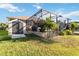 Lush backyard view with shed and screened-in patio, showcasing outdoor space for storage and relaxation at 15578 Seafoam Cir, Port Charlotte, FL 33981