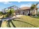 Lush backyard showcasing screened-in patio, providing a seamless transition between indoor and outdoor living at 15578 Seafoam Cir, Port Charlotte, FL 33981