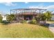 Lush backyard view of the screened lanai, offering a private outdoor retreat and serene waterfront view at 15578 Seafoam Cir, Port Charlotte, FL 33981