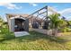Expansive backyard view featuring shed and screened-in patio, ideal for storage and outdoor entertaining at 15578 Seafoam Cir, Port Charlotte, FL 33981