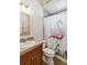 Full bathroom features a flamingo patterned shower curtain and a single sink vanity at 15578 Seafoam Cir, Port Charlotte, FL 33981