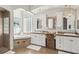 Elegant primary bathroom with dual sinks, a soaking tub, walk-in shower, and decorative mirrors at 15578 Seafoam Cir, Port Charlotte, FL 33981