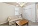 Cozy room features a neutral couch, side table, coffee table, and double closets at 15578 Seafoam Cir, Port Charlotte, FL 33981