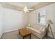Bright room features a neutral couch, side table and a coffee table with large shuttered window at 15578 Seafoam Cir, Port Charlotte, FL 33981