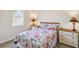 Comfortable bedroom with floral bedding, white dressers and a window at 15578 Seafoam Cir, Port Charlotte, FL 33981