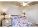 Comfortable bedroom offers floral bedding, white dressers, and a ceiling fan at 15578 Seafoam Cir, Port Charlotte, FL 33981