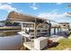 Covered boat dock featuring a boat lift and plenty of room to prepare for a fun day of boating at 15578 Seafoam Cir, Port Charlotte, FL 33981
