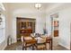 Charming dining room with wood table, decorative rug, and a hutch for storage at 15578 Seafoam Cir, Port Charlotte, FL 33981